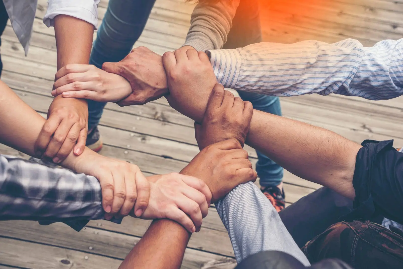 a circle of hands linked together, symbolizing severe mental illness support