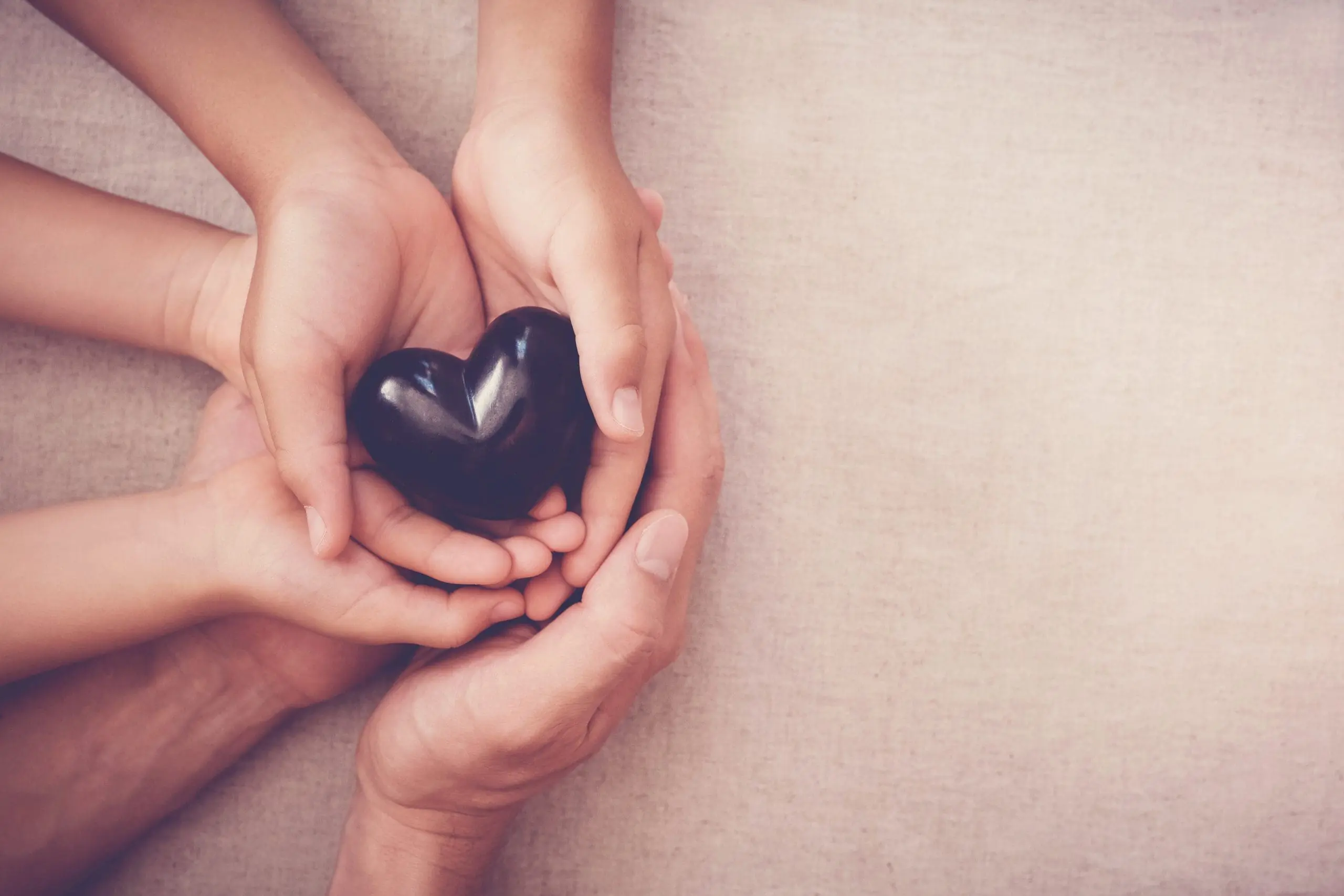 hands holding a black heart, symbolizing grief from ambiguous loss from severe mental illness
