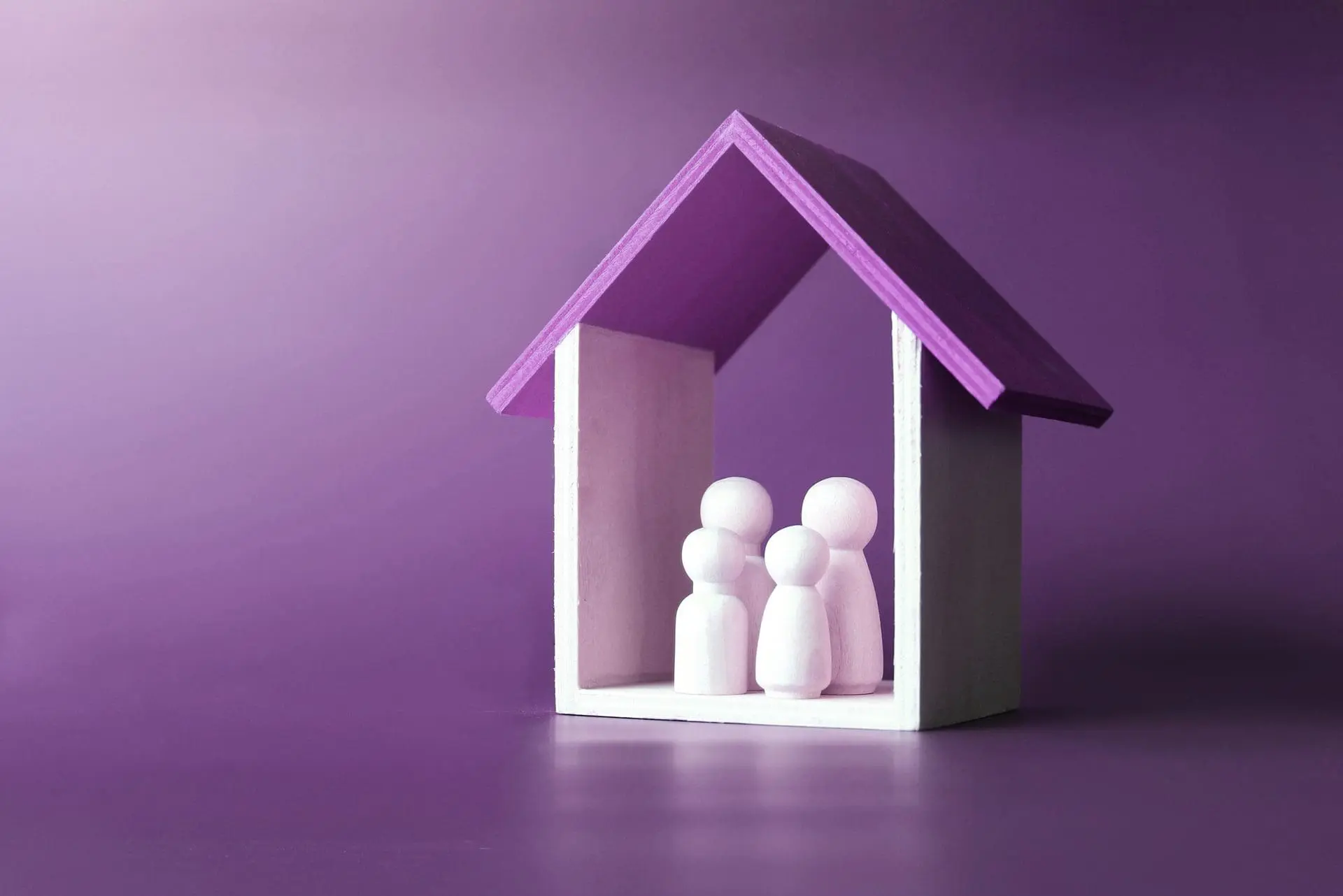 four wooden people sheltered inside of a wooden house outline, symbolizing a safety plan for severe mental illness