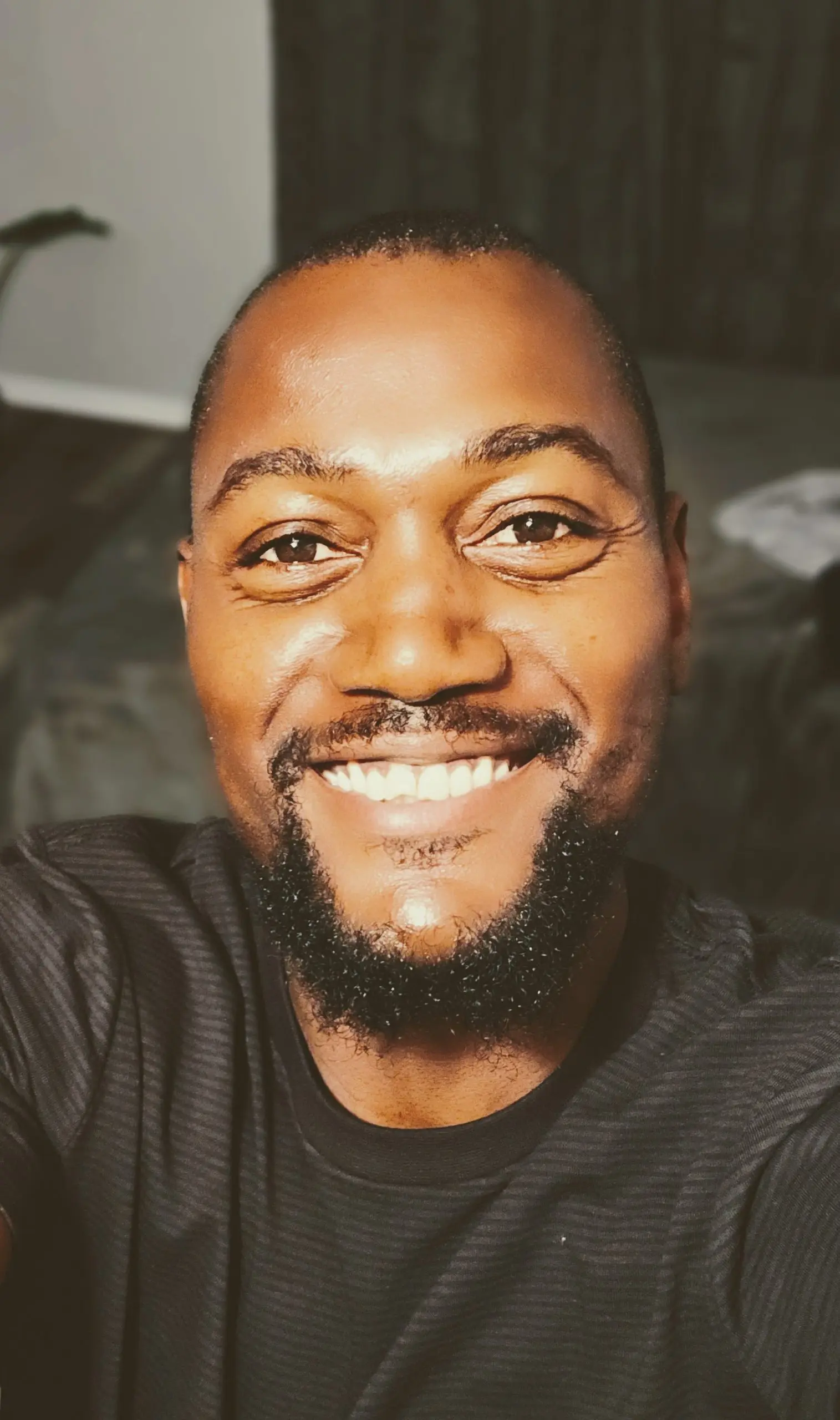 The author Andrew Wilson smiling looking up at the camera.